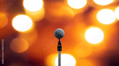 Public speaking backgrounds, Close-up the microphone on stand for speaker speech presentation stage performance with technology blur bokeh light background.