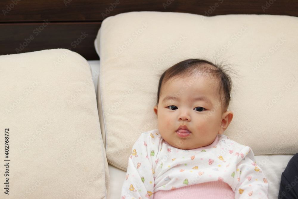 寝室のベッドで寝転がる赤ちゃん 寝室のベッドで寝転がる赤ちゃん