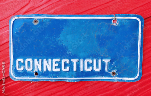 Classic license plate on red background.