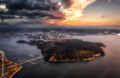 Beautiful Aerial View of Lions Gate Bridge, Stanley Park and Vancouver Downtown, British Columbia, Canada. Colorful Sunset Artistic Render photo