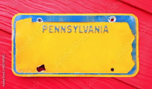 Classic license plate on red background.