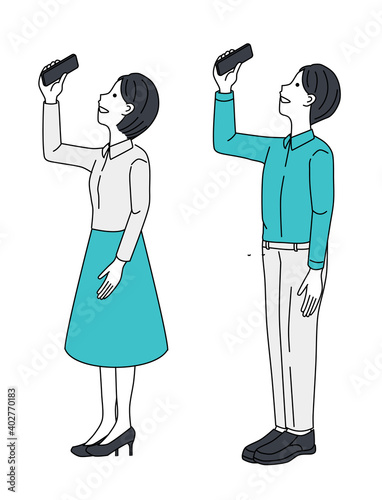 A couple taking pictures with a smartphone