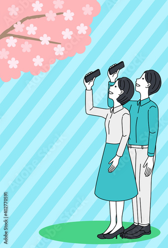 Man and woman taking pictures of cherry blossoms