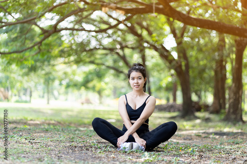 Asian young woman doing stretching or warm up outdoor in the park. Sport woman fitness exercise outdoor. Wearing sportswear, Working out, resting outdoor. People, Sport, healthy