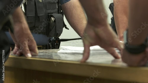 Police Leaning on Table During Meeting Close Up 4K