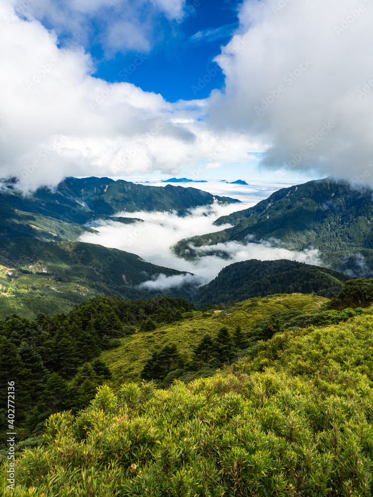 Smoke and fog over the landscapes. beautiful mountains with blue sky, Mount Hehuan, Taiwan Smoke and fog over the landscapes. beautiful mountains with blue sky, Mount Hehuan, Taiwan