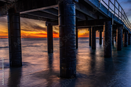 The view from underneath the jetty at sunset, at Coogee Beach, Perth. 