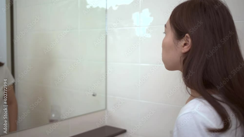 Unrecognizable woman using mouthwash after brushed tooth. Unrecognizable woman using mouthwash after brushed tooth.