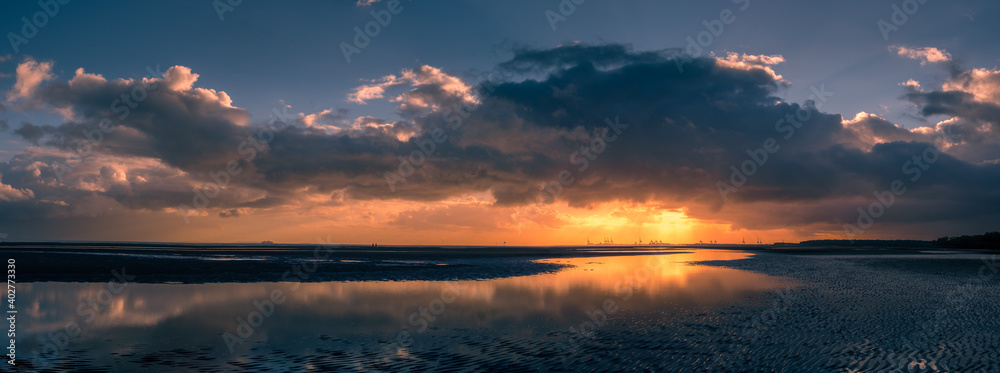 Beautiful Panoramic Seaside Sunrise with Cloud Reflections
