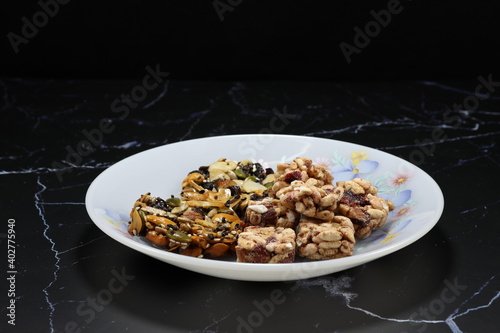 Pile of Classic baked mixed nut and grain serving on the plate. Famous traditional welcome sweet snack in Asia party. 