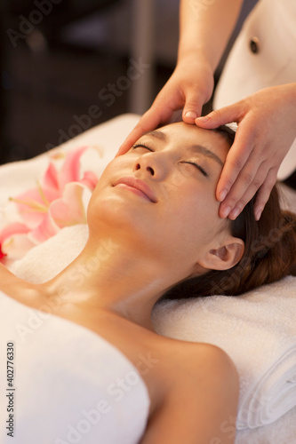 A young women lying in bed enjoying massage