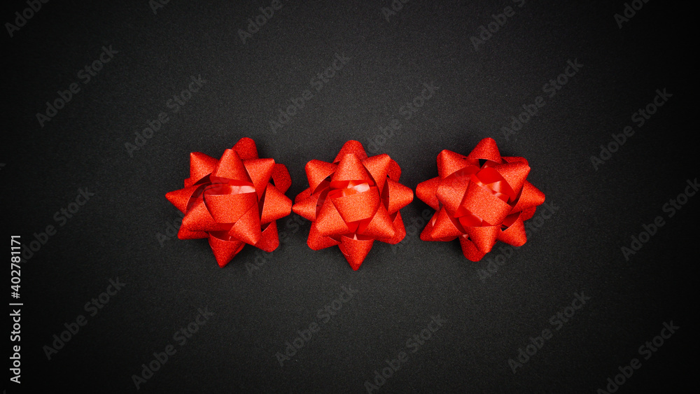 Red sparkling star ribbons on Black background Red sparkling star ribbons on Black background