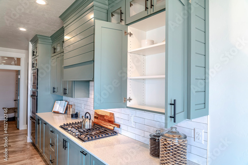 Photography Built in cabinets and cooking units inside the kitchen of a home with appliances