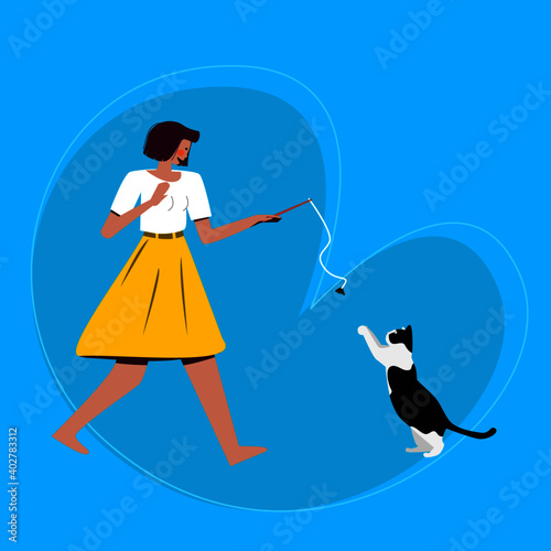 a woman plays with a cat. . playing with a pet