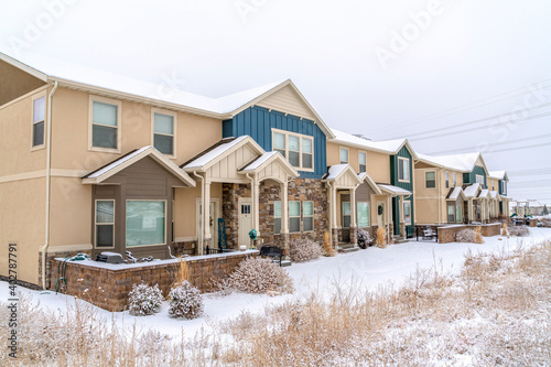 Apartment facade on a winter neighborhood with snow and cloudy sky views