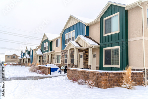 Facade of apartment homes amidst a snowy neighborhood scenery in winter