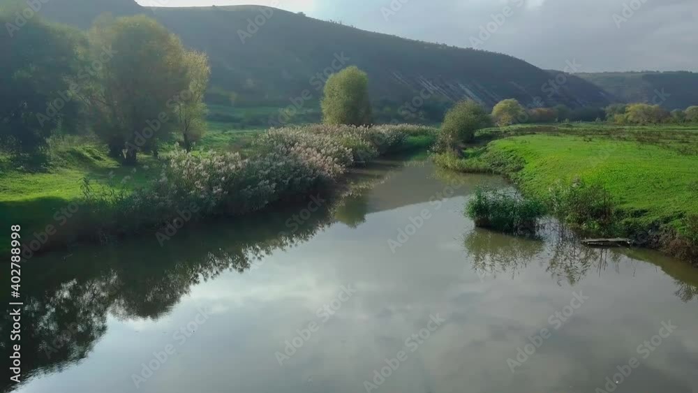 Drone flight over the river and smal moldavian village in autumn landscape. Moldova republic of. Drone flight over the river and smal moldavian village in autumn landscape. Moldova republic of.