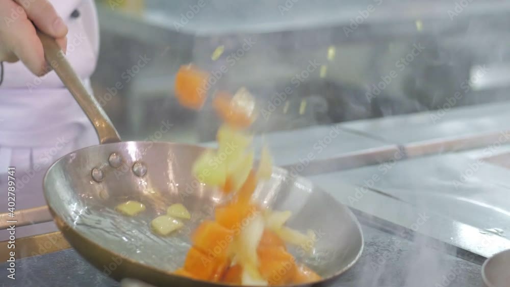 Chef cooking vegetables in pan in the kitchen of the restaurant or hotel Chef cooking vegetables in pan in the kitchen of the restaurant or hotel