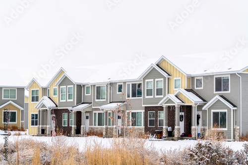 Apartments on a winter setting amidst snowy ground and cloudy white sky