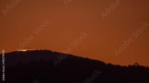 Big sun close-up rising at mountain.	 Beautiful nature video time lapse landscape.