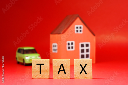 Tax word on blur home and car vehicle background - Red pattern of Business and Planning cost investment concept - Calculate Reduce Taxes or Taxes back and return 