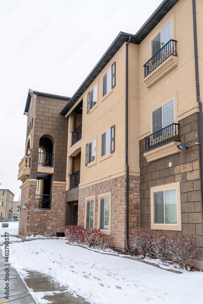 Multi storey apartment in a snowy neighborhood against white sky in winter Multi storey apartment in a snowy neighborhood against white sky in winter