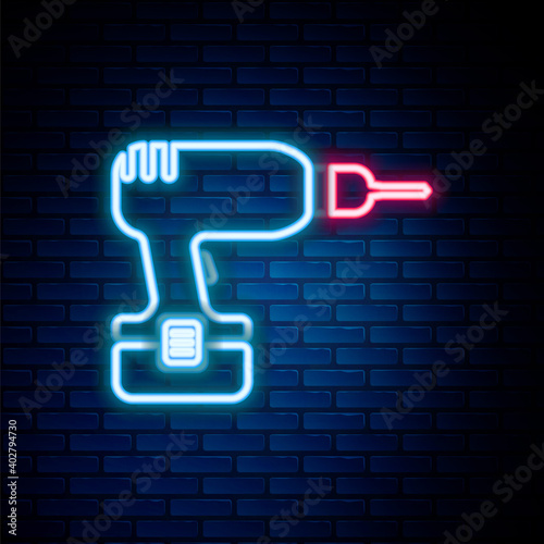 Glowing neon line Drill machine icon isolated on brick wall background. Colorful outline concept. Vector.