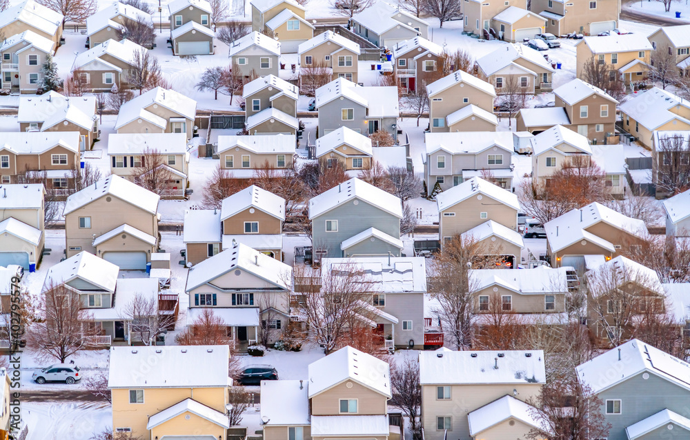 Aerial view of a scenic town in the valley with houses against snowy landscape