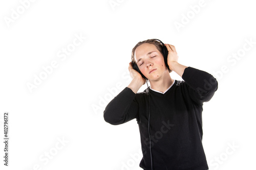 Student on a white background. Young attractive guy listens to music.