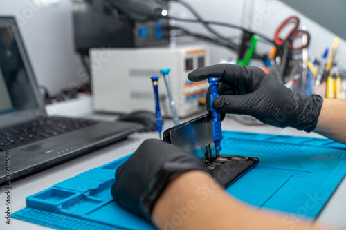 hands of a foreman repairing a cell phone