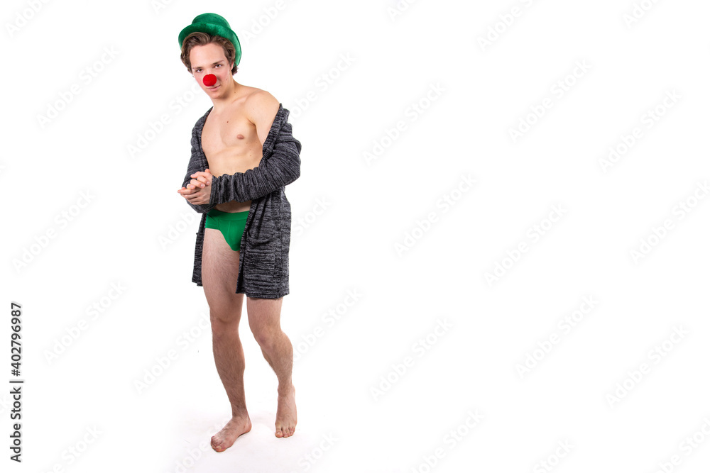 Funny guy in a clown costume. Holidays and fun. Young attractive man on a white background. Funny guy in a clown costume. Holidays and fun. Young attractive man on a white background.