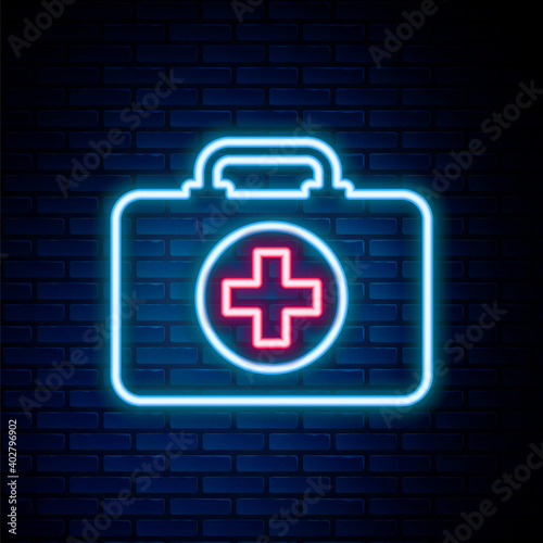 Glowing neon line First aid kit icon isolated on brick wall background. Medical box with cross. Medical equipment for emergency. Healthcare concept. Colorful outline concept. Vector.