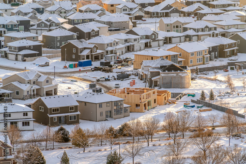 Fototapeta premium Neighborhood landscape in the sunlit snow covered valley terrain in winter