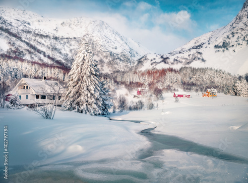 Beautiful winter scenery. Bright morning view of frozen river in Valberg village, Lofoten Islands, Norway, Europe. Picturesque winter scene over polar circle. Traveling concept background.