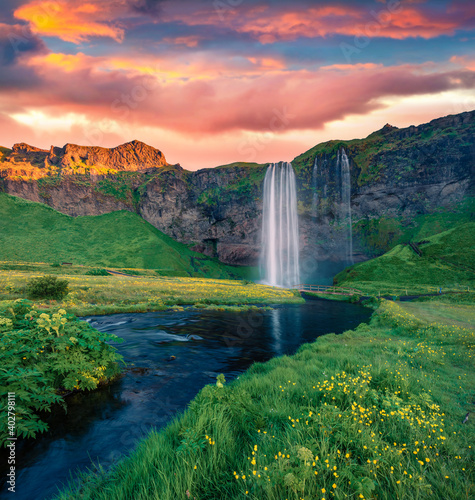 Beautiful summer scenery. Picturesque sunrise on Seljalandfoss Waterfall. Exciting outdoor scene of Seljalandsa rive. Perfect summer morning in Iceland, Europe.
