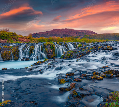 Beautiful summer scenery of Bruarfoss Waterfall, secluded spot with cascading blue waters. Magnificent sunset in Iceland, Europe. Landscape photography.. © Andrew Mayovskyy
