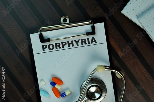 Porphyria write on a paperwork isolated on Wooden Table. Medical or Healthcare concept photo