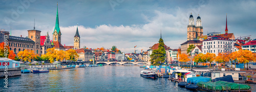 Beautiful autumn scenery. Panoramic morning view of Fraumunster and Grossmunster Churches. Splendid autumn cityscape of Zurich, Switzerland. Morning on Limmat River.