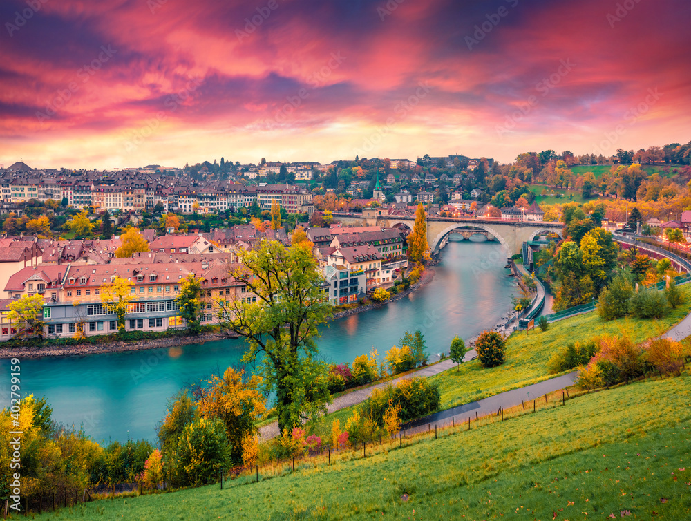 Landscape photography. Fantastic evening view of Bern town with Pont de Nydegg bridge and Nydeggkirche - Protestant church on background. Autumn sunset in Switzerland, Aare River, Europe.