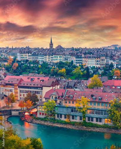 Wonderful evening cityscape of Bern town with Cathedral of Bern on background. Impressive autumn sunset on Switzerland, Aare River, Europe. Traveling concept background.