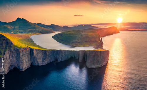 Magnificent evening view from flying drone of Sorvagsvatn lake, Vagar, Faroe Islands, Denmark, Europe. Majestic summer sunset on Atlantic Ocean. Beautiful summer scenery.. photo