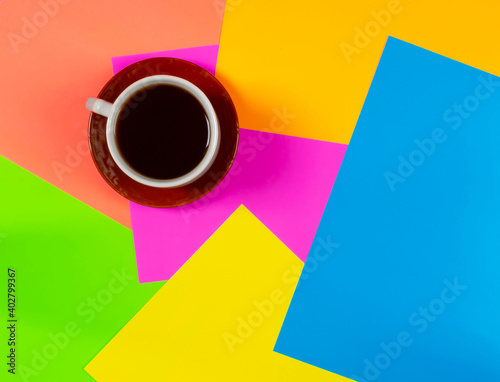 Cup of coffee on colorful background. With space for your text