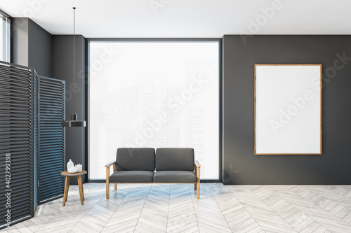Mockup frame in grey hall with sofa and small table, wooden screen