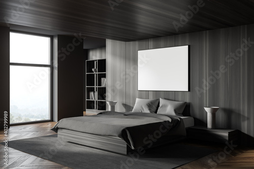 Dark wooden and gray master bedroom conrer with poster