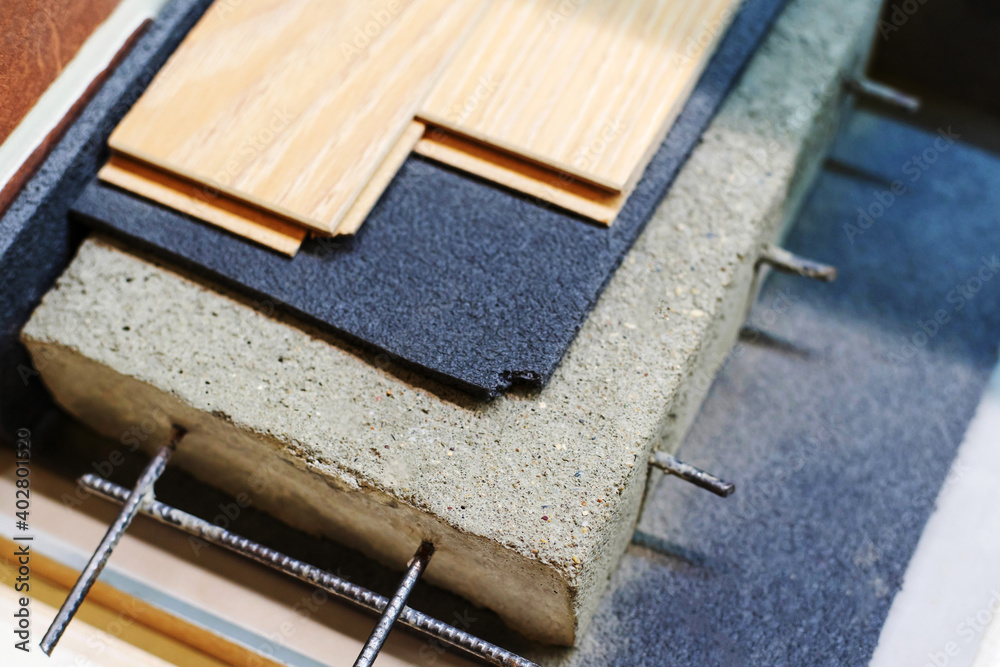 Insulation of the concrete floor and laying the floor covering. Abstract in miniature ways and technological solutions. Close-up Insulation of the concrete floor and laying the floor covering. Abstract in miniature ways and technological solutions. Close-up