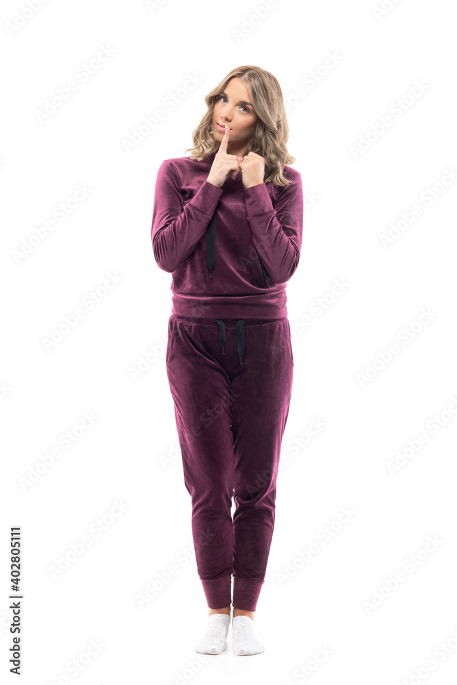 Cute beauty girl in casual comfy home clothes showing finger on lips mystery gesture. Full body length isolated on white background. Cute beauty girl in casual comfy home clothes showing finger on lips mystery gesture. Full body length isolated on white background.