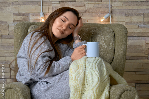 Meditating girl sitting in a chair with a cup of tea