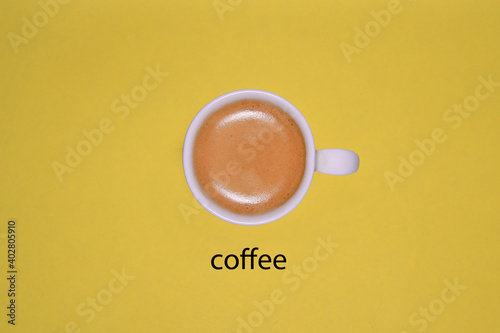 Cup of coffee on a yellow background to start a day.