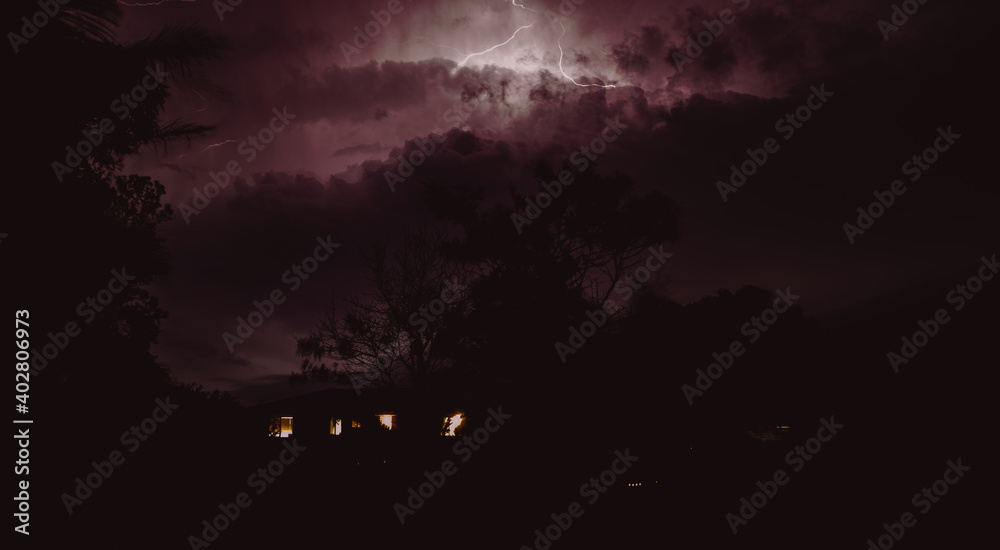 Storm sky with a silhouette of a house 