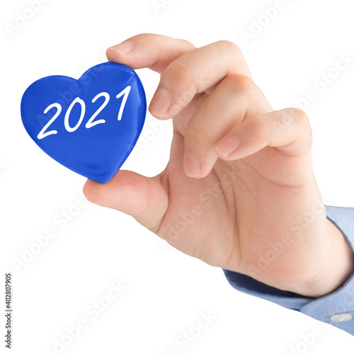 Male hand and blue heart 2021 isolated against white background